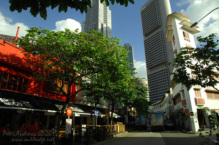 Below the OCBC Centre building that was built in 1976, the restaurants and small bars along Circular Road at Boat Quay in Singapore prepare for another busy evening of trade. Photo &copy; Peter Andrews / Outimage. Walking from Circular Road to Chinatown in Singapore as the city prepares for the Lunar New Year.