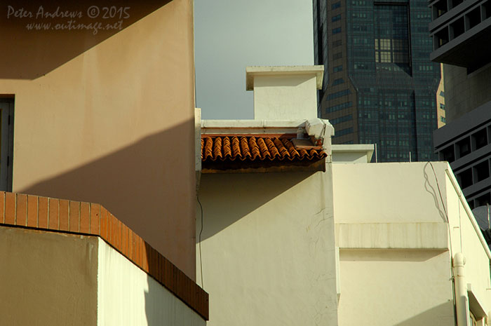 Mixed architecture of the old overshadowed with the new, along Lorong Telok in the Boat Quay area of Singapore city. Photo &copy; Peter Andrews / Outimage. Walking from Circular Road to Chinatown in Singapore as the city prepares for the Lunar New Year.
