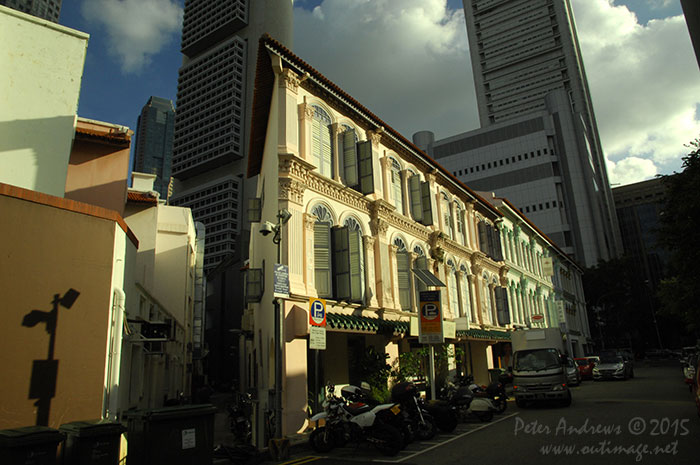 Mixed architecture of the old overshadowed with the new, along Lorong Telok in the Boat Quay area of Singapore city. Photo &copy; Peter Andrews / Outimage. Walking from Circular Road to Chinatown in Singapore as the city prepares for the Lunar New Year.