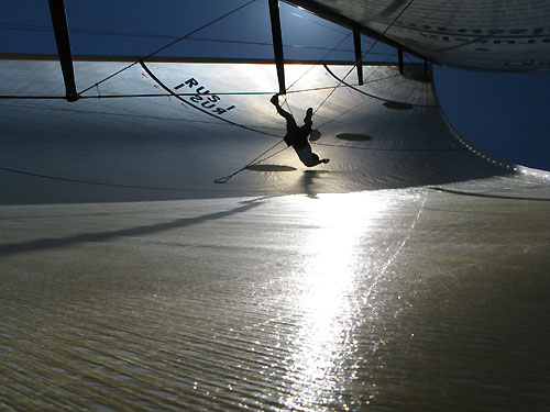 Ben Costello mends a sail onboard Team Russia, during calm conditions earlier on leg 1 of the Volvo Ocean Race. Photo copyright Mark Covell - Team Russia - Volvo Ocean Race.