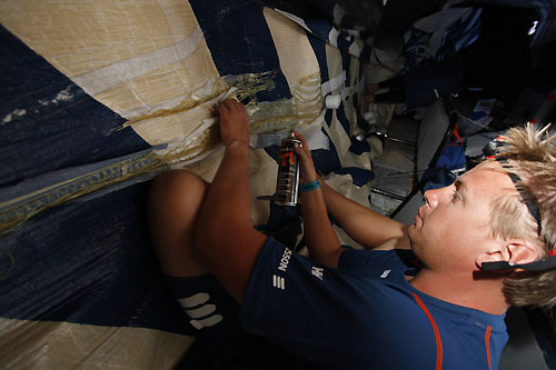 Martin Stromberg repairs Ericsson 3's jib below decks. The jib got caught on the radar, ripping the sail and bringing the radar down during a tack shortly after they crossed the start line on leg 2 from Cape Town, South Africa to Cochin, India. Photo copyright Gustav Morin / Ericsson 3 / Volvo Ocean Race.
