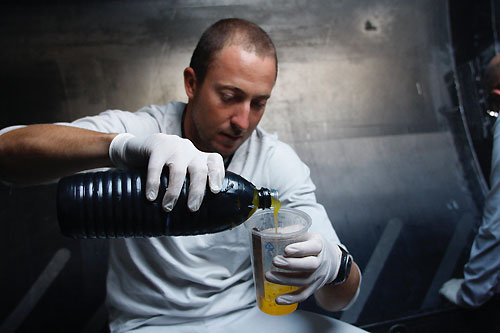 Andrew McLean carefully mixing resin for repairs on Green Dragon, on leg 4 of the Volvo Ocean Race, from Singapore to Qingdao, China. Photo copyright Guo Chuan / Green Dragon Racing / Volvo Ocean Race.