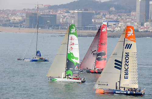 Green Dragon (Ian Walker / GBR) was first over the line in a slow-motion start in-front of her home town crowd, only to relinquish to the lead to PUMA Ocean Racing (Ken Read / USA). Start Day for Leg 5 of the Volvo Ocean Race from Qingdao, China, to Rio De Janeiro. Photo copyright Rick Tomlinson / Volvo Ocean Race.
