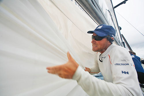 Magnus Woxen changing sails, onboard Ericsson 3, while PUMA Ocean racing and Ericsson 4 lurk over on the horizon. Photo copyright Gustav Morin / Ericsson 3 / Volvo Ocean Race.