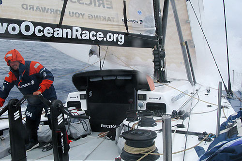 Joao Signorini grinding as a wave hits Ericsson 4, on leg 5 of the Volvo Ocean Race, from Qingdao to Rio de Janeiro. Photo copyright Guy Salter / Ericsson 4 / Volvo Ocean Race.