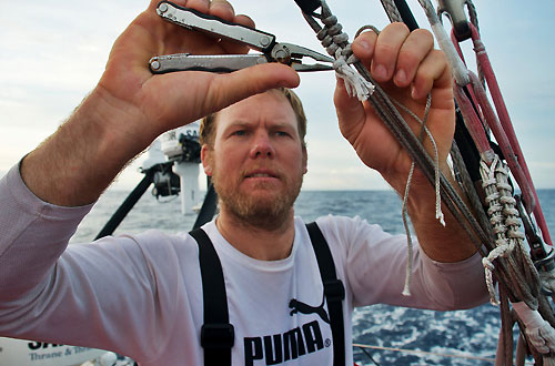 Casey Smith repairing a runner, onboard PUMA Ocean Racing, on leg 5 of the Volvo Ocean Race, from Qingdao to Rio de Janeiro. Photo copyright Rick Deppe / PUMA Ocean Racing / Volvo Ocean Race.