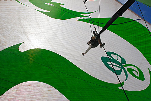 Andrew McLean reapiring ther mainsail, on leg 6 of the Volvo Ocean Race, from Rio de Janeiro to Boston. Photo copyright Guo Chuan / Green Dragon Racing / Volvo Ocean Race.
