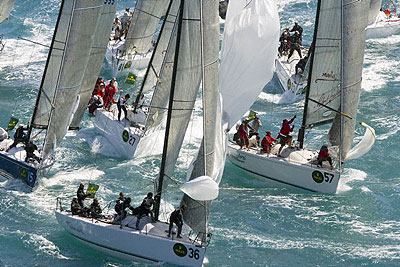 Ole van der Heide's Asterisk (DEN), Deneen Demourkas' Groovederci 57 (USA) and the Farr 40 fleet setting spinnakers after rounding the windward mark. Photo copyright ROLEX Daniel Forster.