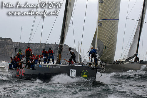 Ludde Ingvall's 90 foot maxi YuuZoo and Niklas Zennstr&ouml;m's R&aacute;n, outside the heads after the start of the Rolex Sydney Hobart 2010. Photo copyright Peter Andrews, Outimage Australia.
