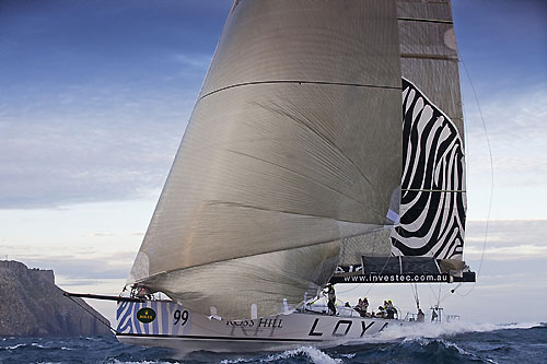 Sean Langman's 100-foot Elliott Investec Loyal, rounding Tasman Island during the Rolex Sydney Hobart 2010. Photo copyright Rolex and Daniel Forster.