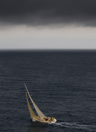 Angus Fletcher's Tevake II under some dark clouds from an approaching southerly buster storm front rolling up the New South Wales South Coast, ahead of the first night at sea after the start of the Rolex Sydney Hobart Yacht Race 2010, Australia. Photo copyright Carlo Borlenghi, Rolex.